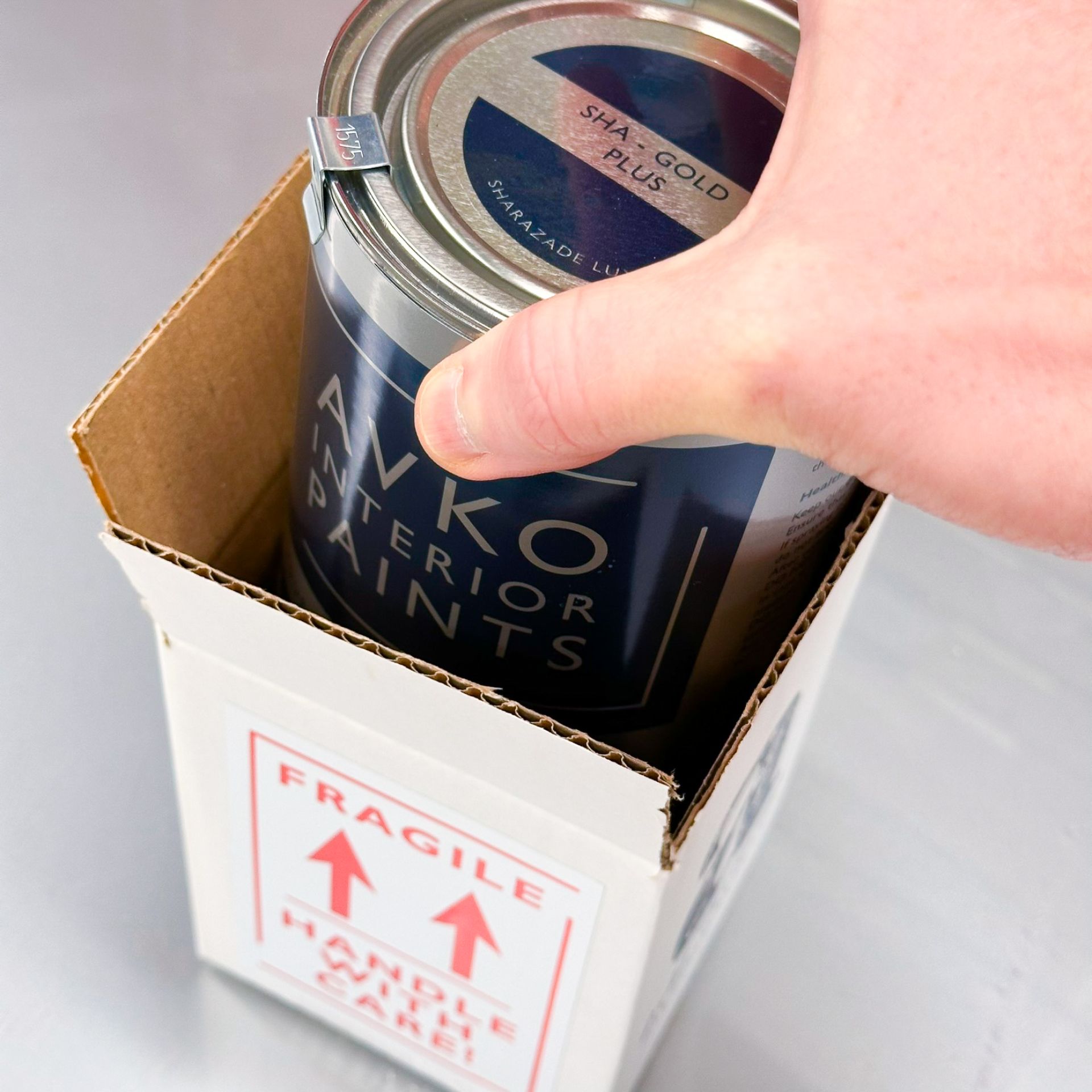 Avko Interior paint can next to an iPad